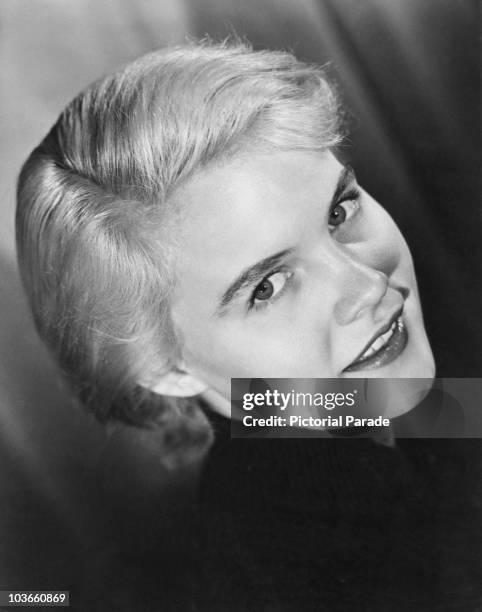Headshot of actress Carroll Baker pictured smiling in a publicity portrait, USA, circa 1960.