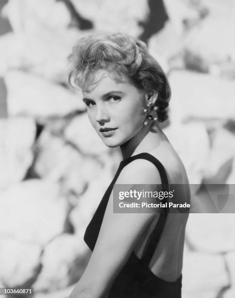 Actress Carroll Baker pictured in a publicity portrait, USA, circa 1960. Baker is wearing a black backless dress.