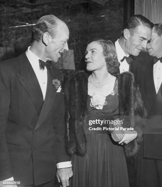 Actor and dancer Fred Astaire and his wife, Phyllis Potter, dressed in evening wear attending a party, USA, circa 1950. Astaire is wearing a tuxedo...