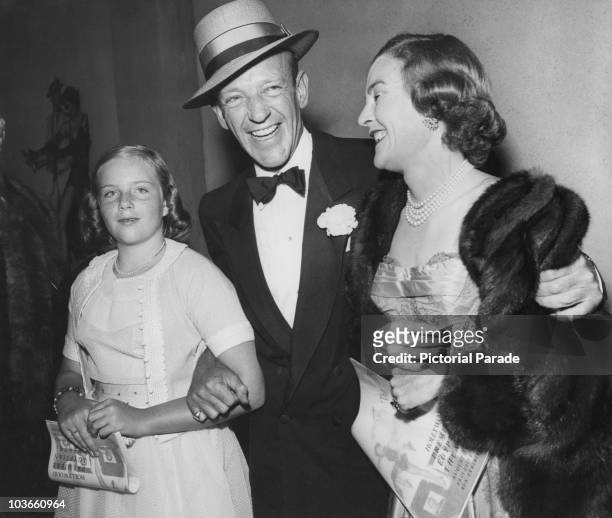 Actor and dancer Fred Astaire and his wife, Phyllis Potter with their daughter, Ava Astaire, dressed in evening wear attending a film premiere at...