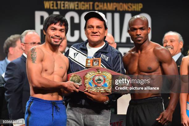 April 8, 2016; Las Vegas, Nev., USA; Manny Pacquiao and Timothy Bradley pose pose with former Panamanian boxer Roberto Duran for photos with the WBO...