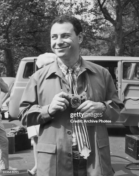 Actor Alan Arkin, with a camera around his neck, in a scene from 'The Love Song of Barney Kempinski' for television drama 'ABC Stage 67', in New...