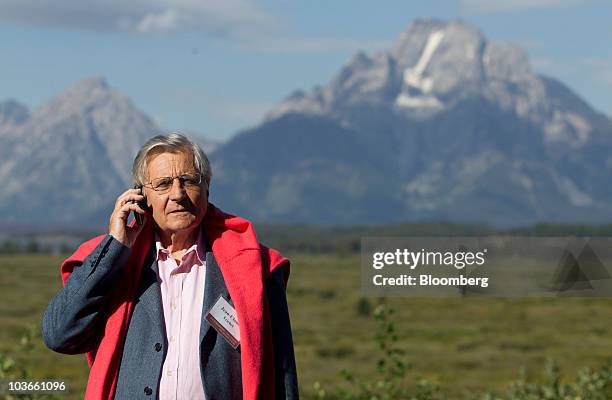 Jean-Claude Trichet, president of the European Central Bank , talks on a mobile phone during a break of the Federal Reserve Bank of Kansas City...