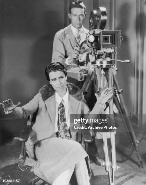 Film director Dorothy Arzner pictured on directing 'Fashions For Women', USA, circa 1927. A man operating a camera is seen behind Arzner.