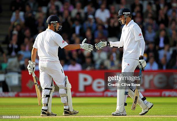 Stuart Broad of England shakes hands with Jonathan Trott after reaching his half century during day two of the 4th npower Test Match between England...