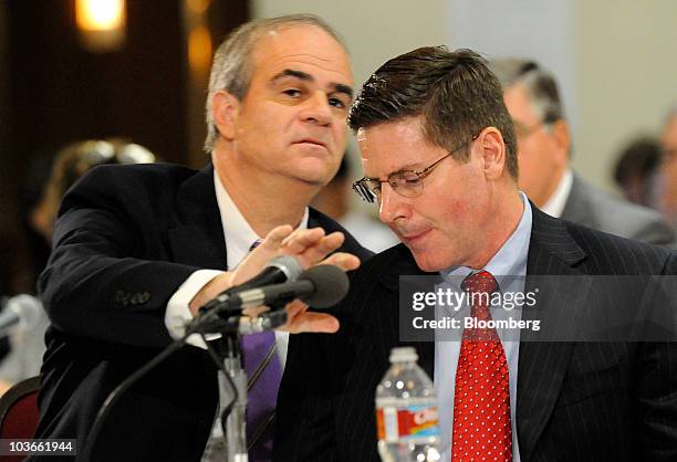 Attorney Philip Hilder, covers the microphone as he confers with his client Brett Cocales, drilling engineer for BP Plc, during the Deepwater Horizon...