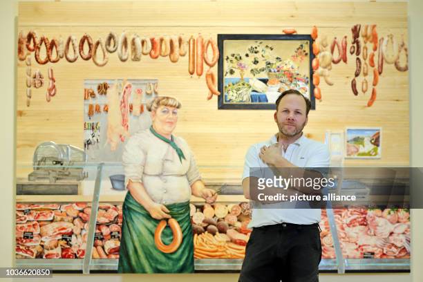 Artist Marc Fromm standing in front of his work 'Metzgerin' in Halle, Germany, 27 February 2017. The wood sculptor, who was born in Hesse in 1971,...