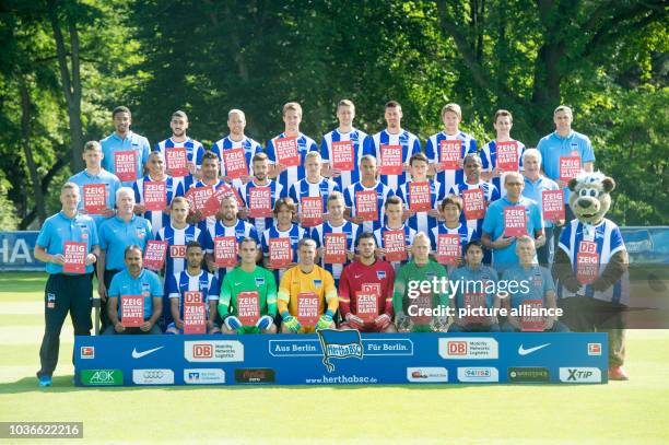 Hertha BSC players hold red cards in their hands which read 'Zeig Rassismus die Rote Karte' during a photo session for the forthcoming 2014/2015...