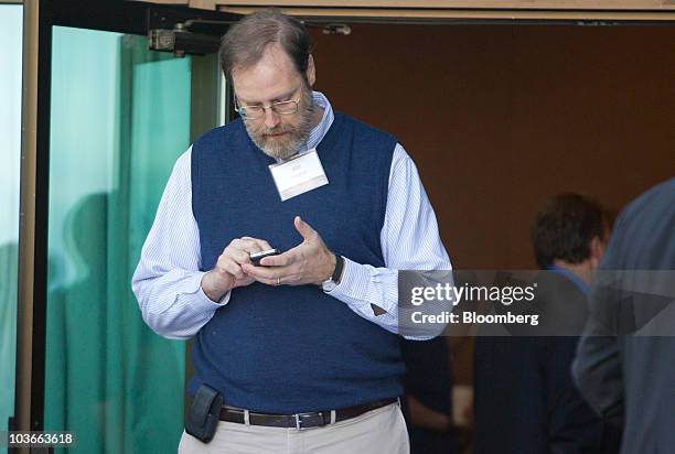 William English, deputy director of monetary affairs with the U.S. Federal Reserve, checks his mobile phone during a break of the Federal Reserve...