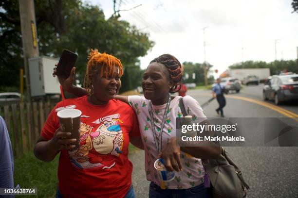 Women embrace after leaving the business park where multiple people were killed and injured in a shooting on September 20, 2018 in Aberdeen,...