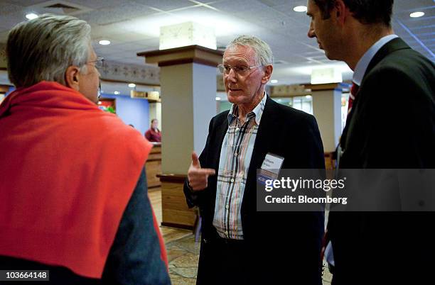 William White, chair of the economic and development review committee of the Organization for Cooperation and Development , center, speaks to...