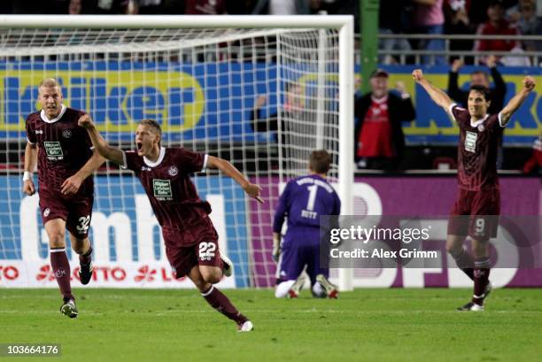 Ivo Ilicevic of Kaiserslautern celebrates his team's first goal with team mates Adam Nemec and Srdjan Lakic as goalkeeper Hans Joerg Butt of Muenchen...