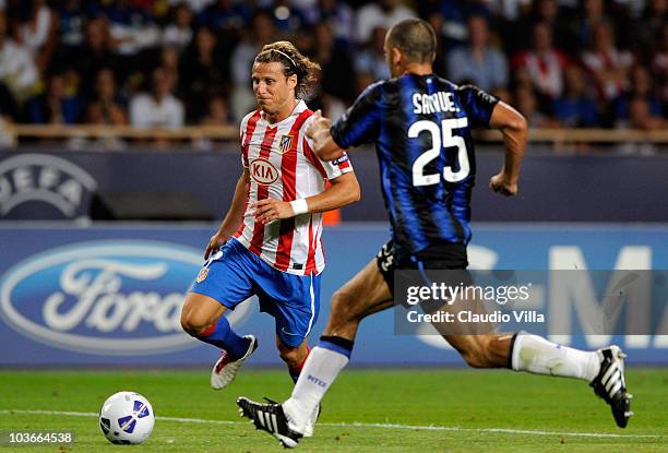 Walter Samuel of Inter Milan and Diego Forlan of Atletico Madrid compete for the ball during the UEFA Super Cup between Inter and Atletico Madrid at...