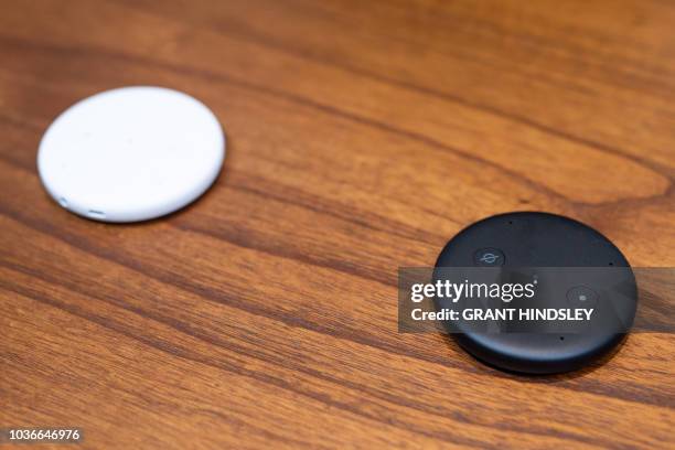 The Echo Input, a device aimed at connecting existing speakers to Alexa, is displayed in Amazon's Day 1 building in Seattle on September 20, 2018. -...