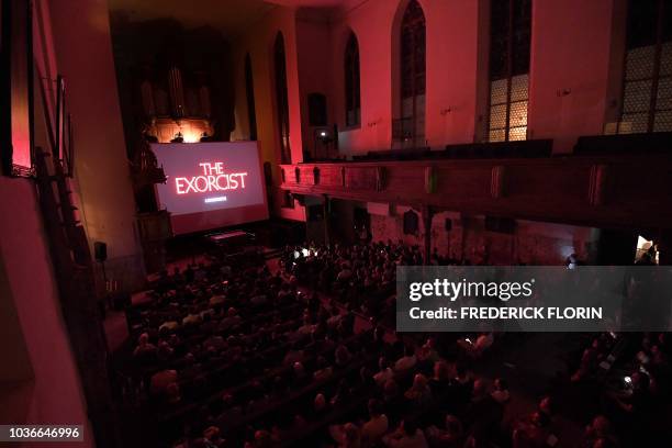 People attend a projection of the movie "The Exorcist" at the Saint Guillaume Protestant Church on September 20, 2018 in the eastern French city of...