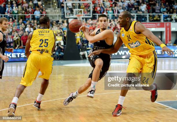 Bamberg's Daniel Schmidt veis for the ball with Berlin's Je'Kel Foster and Ali Traore pass the ball to a teammate during the Euroleague group E...