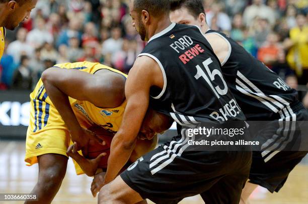 Bamberg's Casey Jacobsen tries to block Berlin's Sharrod Ford and Nihad Djedovic vei for the ball during the Euroleague group E intermediate...
