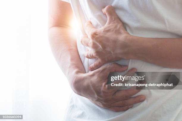 stomachache,businessman stomachache - male stomach stock pictures, royalty-free photos & images