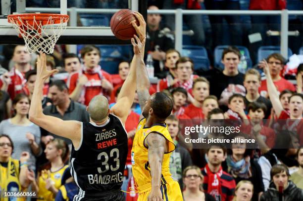 Bamberg's Maik Zirbes tries to stop Berlin's Je'Kel Foster from making a basket during the Euroleague group E intermediate basketball round match...