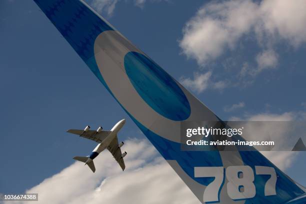 The Airbus A380 flies over Boeing 787-9 airplane at the Farnborough Airshow-2014, UK.