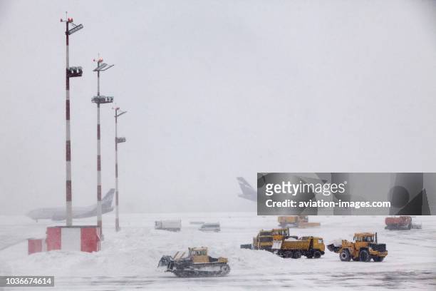 The tarmac of Moscow-Sheremetyevo airport is covered with snow as a snowstorm causing delays and poor weather conditions forces the ramp cleaning...