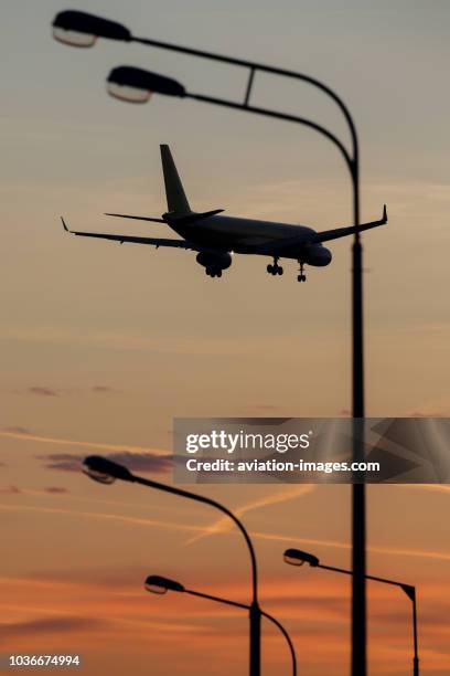 The Tupolev Tu-204 airplane silhouettes against the sunrise sky as arriving Sheremetyevo airport, Moscow Region, Russia.