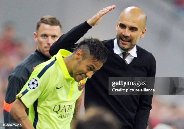 Bayern Munich's head coach Josep Guardiola and Barcelona's Neymar enjoy themselves during the Champions League semi final soccer match FC Bayern...