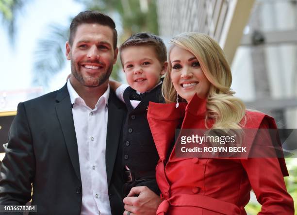 Singer Carrie Underwood poses with her husband Mike Fisher and their 3-year-old son Isaiah Michael at her star unveiling ceremony on the Hollywood...