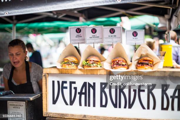 freshly flame grilled vegan burgers displayed in a row - pattie sellers stock pictures, royalty-free photos & images