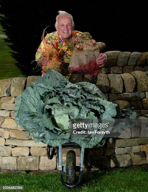 Ian Neale from Newport poses for a media call with his winning Beetroot which won with a weight of 19.315kg, his winning cabbage at a weight of...