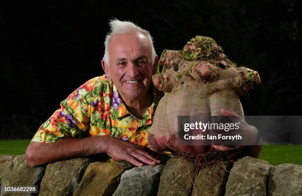 Ian Neale from Newport poses for a media call with his winning Beetroot which won with a weight of 19.315kg after judging takes place for the giant...