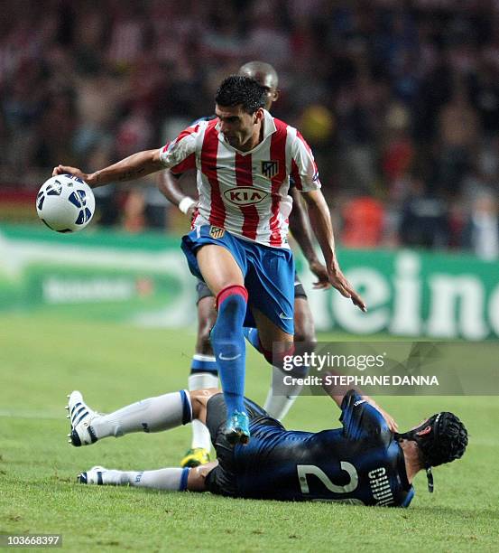 Milan's Cristian Chivu tackles Madrid's Jose Antonio Reyes during the UEFA Super Cup football match Inter Milan vs Club Atletico de Madrid, on August...