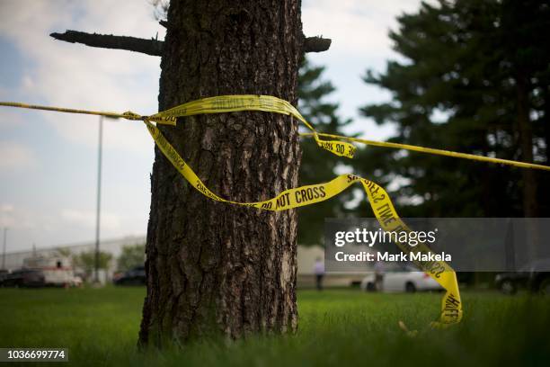 Crime Scene tape flutters in the wind in front of a Rite Aid Distribution Center, where multiple people were killed and injured in a shooting, on...