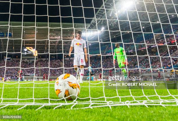 Leipzig's midfielder Diego Demme and Swiss goalkeeper Yvon Mvogo react after the third goal by Salzburg's Norwegian forward Fredrik Gulbrandsen...