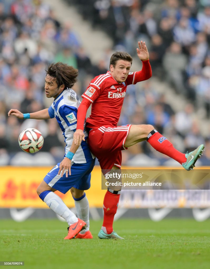 Berlin's Hajime Hosogai and Hamburg's Nicolai Mueller vie for the... News Photo Getty Images Berlin's Hajime Hosogai and Hamburg's Nicolai Mueller vie for the... News Photo Getty Images