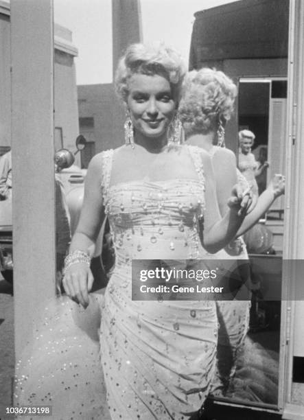 American actress Marilyn Monroe wearing a beaded gown on the set of 'There's No Business Like Show Business', directed by Walter Lang, at the 20th...