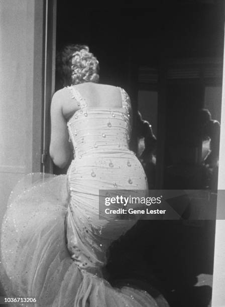 American actress Marilyn Monroe wearing a beaded gown on the set of 'There's No Business Like Show Business', directed by Walter Lang, at the 20th...