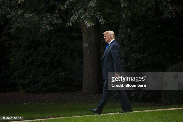President Donald Trump walks on the South Lawn of the White House before boarding Marine One in Washington, D.C., U.S., on Thursday, Sept. 20, 2018....