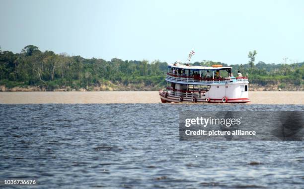 Boats are pictured at the confluence of the Solimões, the upper stretch of the Amazon River, and the Rio Negro near Manaus, Brazil, 11 December 2013....