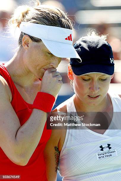 Meghann Shaughnessy and Bethanie Mattek-Sands confer between points while playing Su-Wei Hsieh of Taipei and Shuai Peng of China during the...