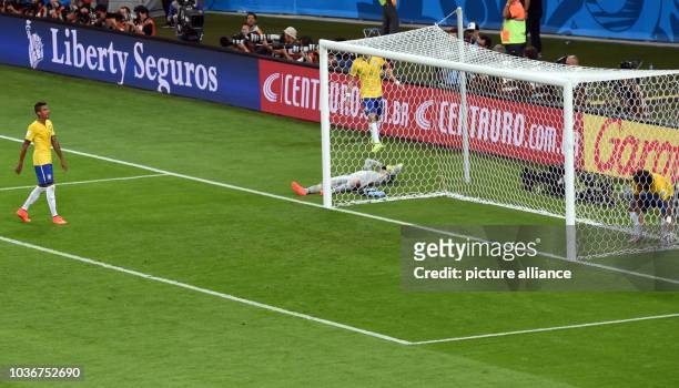 Brazil's Luiz Gustavo , goal keeper Julio Cesar and David Luiz react after a goal during the FIFA World Cup 2014 semi-final soccer match between...