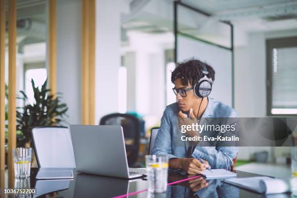 young man is watching videos on internet - learning agility stock pictures, royalty-free photos & images