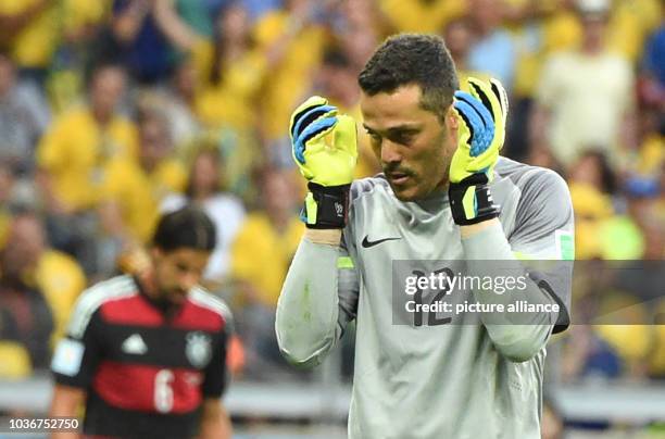 Brazil's goal keeper Julio Cesar gestures during the FIFA World Cup 2014 semi-final soccer match between Brazil and Germany at Estadio Mineirao in...