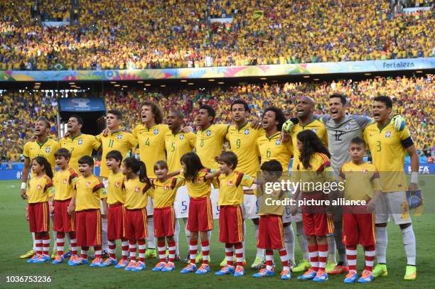 Brazil's players Neymar Jr , Hulk, Oscar, David Luiz, Fernandinho, Paulinho, Fred, Marcelo, Maicon and goalkeeper Julio Cesar and Thiago Silva sing...