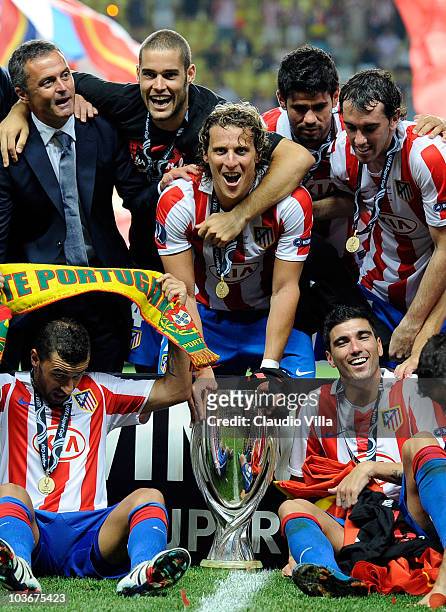 Diego Forlan of Atletico Madrid celebrates with team mates after winning the UEFA Super Cup between Inter and Atletico Madrid at Louis II Stadium on...