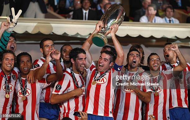 Atletico Madrid captain Antonio Lopez lifts the Super Cup after Atletico's 2-0 win during the UEFA Super Cup match between Inter Milan and Atletico...