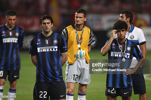 Diego Milito and Coutinho and Inter Milan team-mates stand dejected after their team's 0-2 defeat at the end of the UEFA Super Cup match between...
