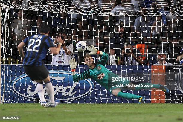 David de Gea of Atletico saves a penalty from Diego Milito of Inter during the UEFA Super Cup match between Inter Milan and Atletico Madrid at Louis...