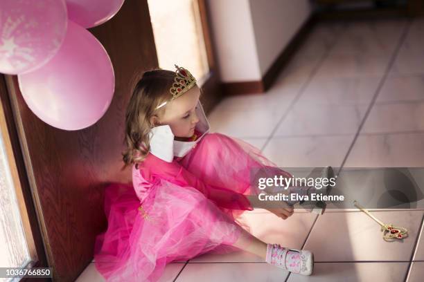 young girl in pink party dress putting on heeled shoes - child high heels stock pictures, royalty-free photos & images