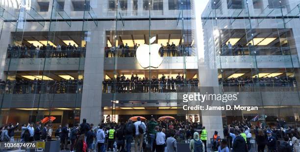 Staff celebrate the first customers at the Australian release of the latest iPhone models at the Apple Store on September 21, 2018 in Sydney,...